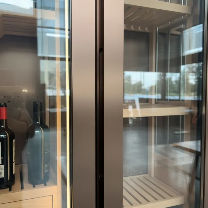 Concealed handle on the glass door of a LivinVino wine cabinet